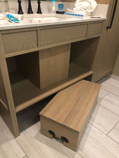 A step beneath the sink in the bathroom helps smaller campers access the vanity and sink. A step beneath the sink in the bathroom helps smaller campers access the vanity and sink.