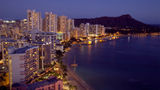 Honolulu at night. Occupancy improved but room rates dipped at Hawaii hotels in July, data shows.