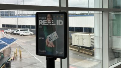 A message board at Charlotte International Airport reminding travelers to get a Real ID.